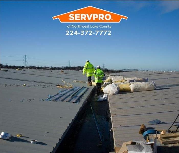 A commercial roof is being inspected and repaired.